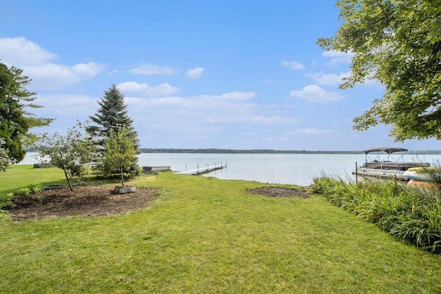 view of yard featuring a dock and a water view