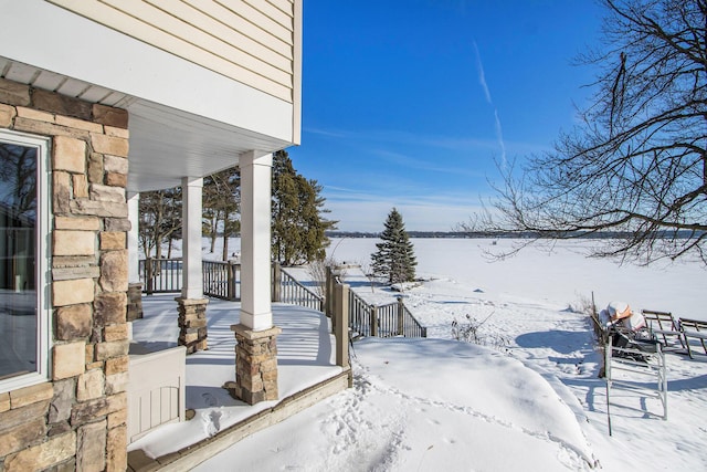 snow covered patio with a porch