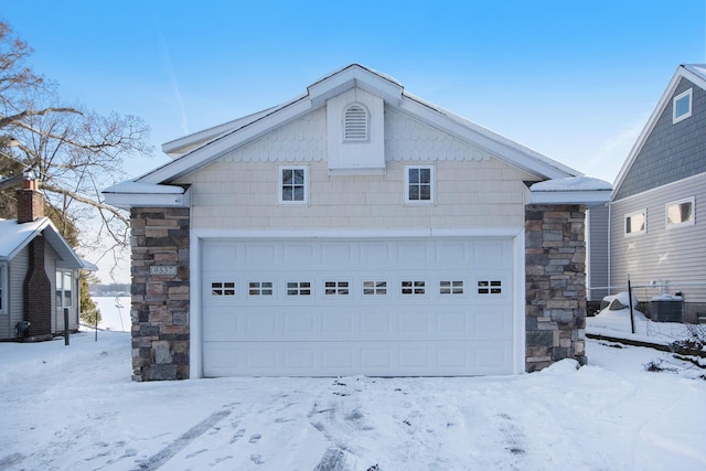 view of front of home with a garage and central AC unit