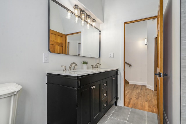 bathroom featuring toilet, vanity, and tile patterned flooring