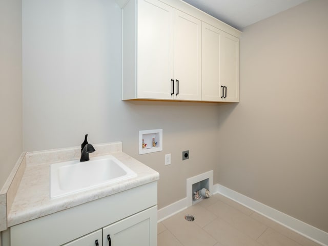 laundry area featuring light tile patterned flooring, sink, hookup for a washing machine, electric dryer hookup, and cabinets