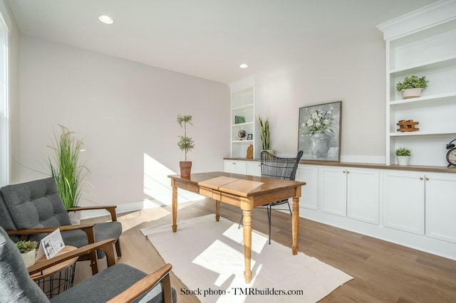 office area featuring light wood-type flooring and built in features