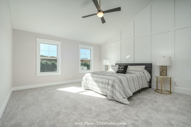 bedroom featuring ceiling fan, lofted ceiling, and light carpet