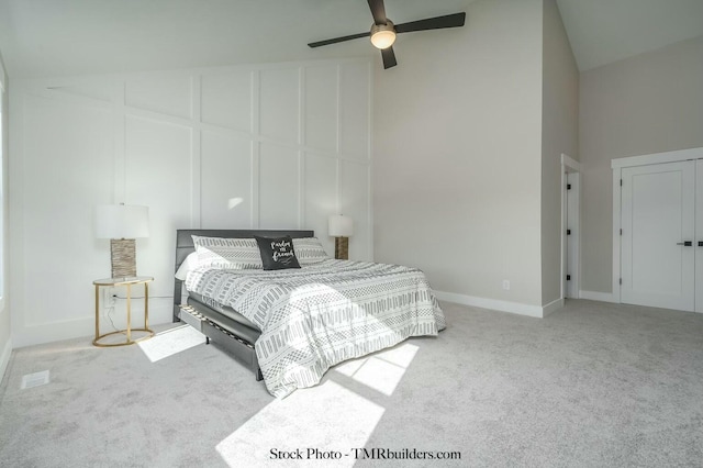 bedroom with carpet, ceiling fan, and high vaulted ceiling