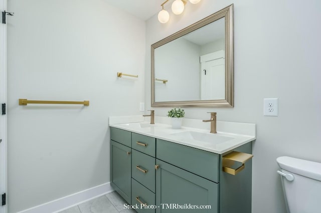 bathroom featuring toilet, vanity, and tile patterned flooring