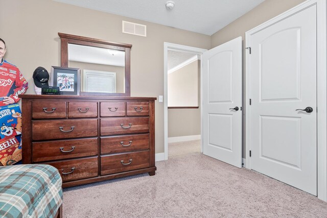 bedroom featuring light colored carpet