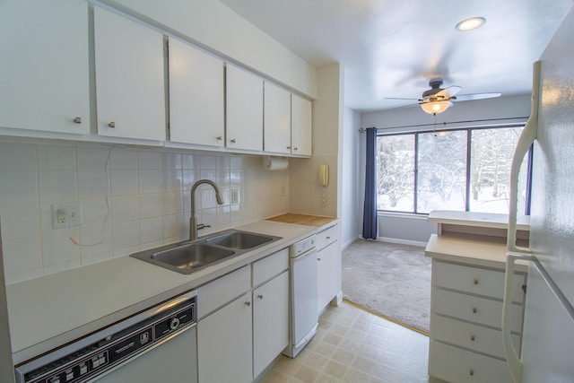 kitchen featuring white refrigerator, dishwasher, white cabinets, and sink