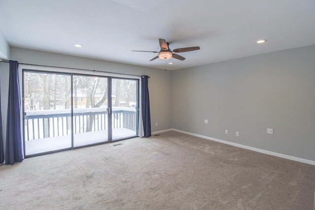 carpeted spare room featuring ceiling fan