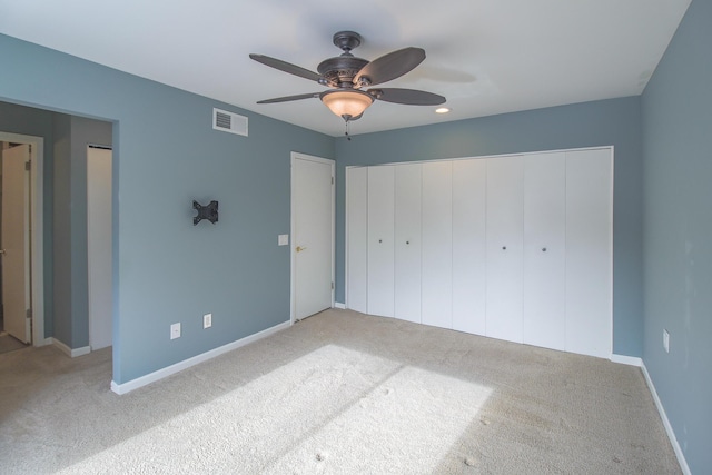 unfurnished bedroom featuring ceiling fan and carpet floors