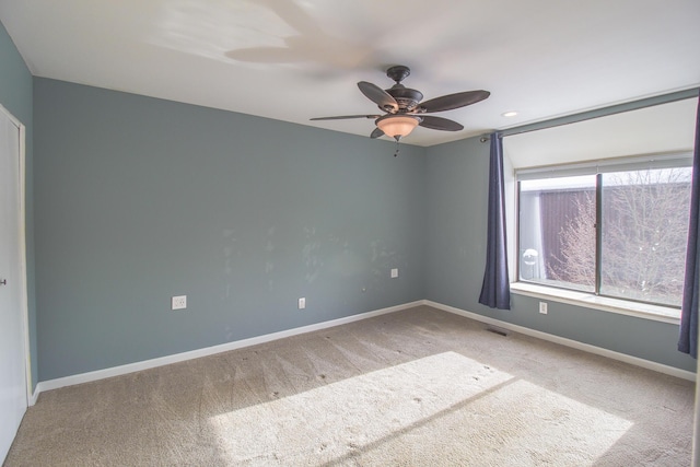 empty room featuring ceiling fan and carpet floors