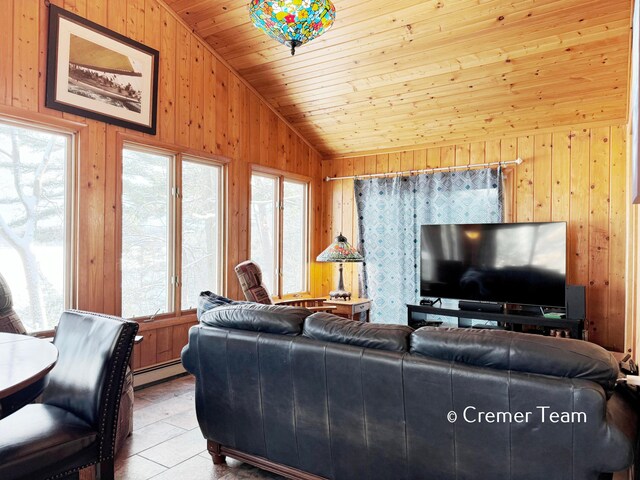 living room featuring lofted ceiling, wood ceiling, a baseboard heating unit, wood walls, and light tile patterned floors