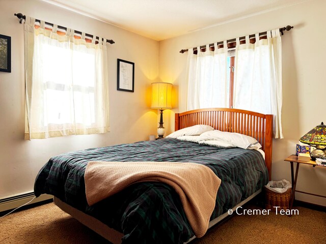 carpeted bedroom featuring baseboard heating