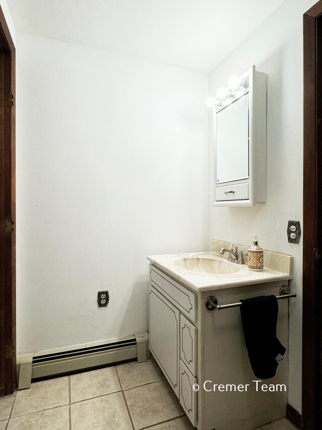 bathroom featuring vanity, tile patterned floors, and baseboard heating