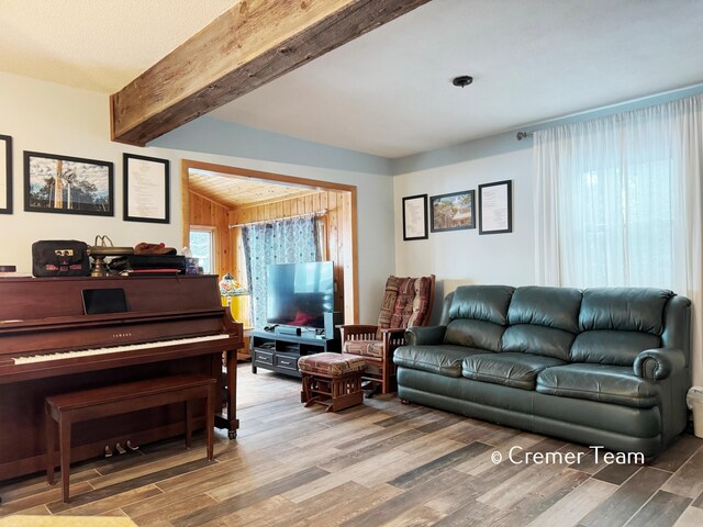 living room with hardwood / wood-style flooring and beam ceiling