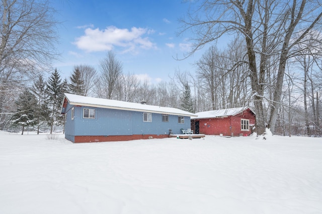 view of snow covered back of property