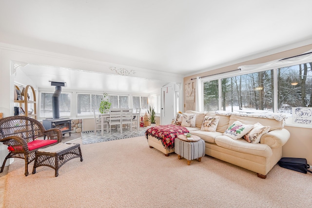 living room featuring carpet flooring, crown molding, and a wood stove