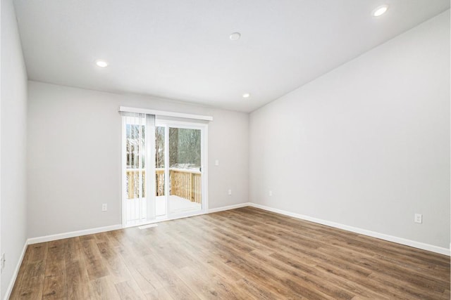 spare room featuring wood-type flooring