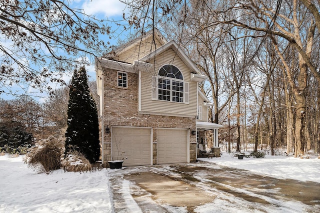 view of snow covered exterior featuring a garage