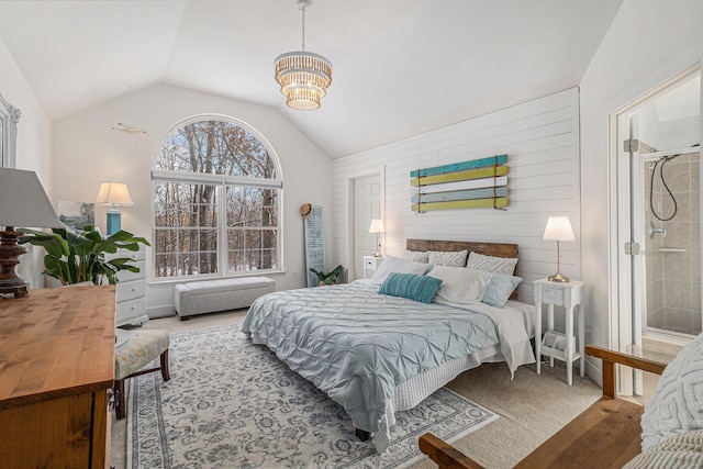 carpeted bedroom featuring ensuite bathroom, wood walls, a chandelier, and lofted ceiling