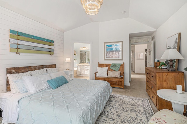 carpeted bedroom featuring connected bathroom, vaulted ceiling, and an inviting chandelier