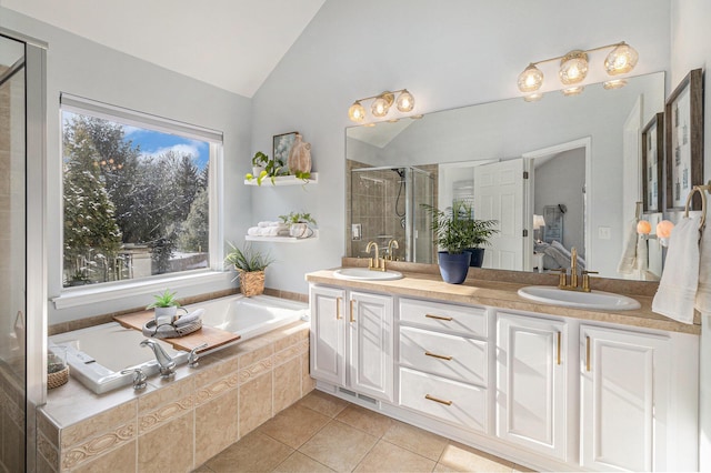 bathroom with vanity, lofted ceiling, independent shower and bath, and tile patterned flooring