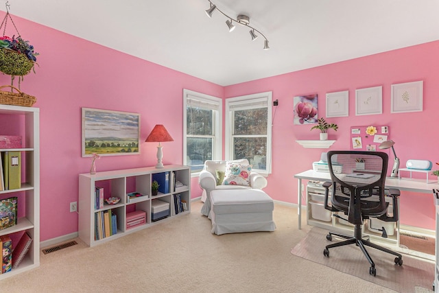 carpeted home office with rail lighting