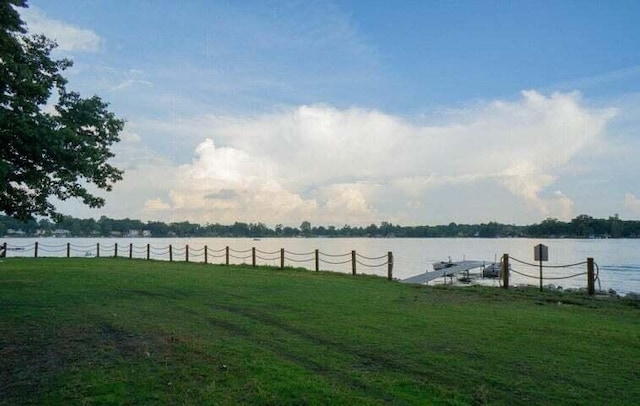 view of yard featuring a dock and a water view