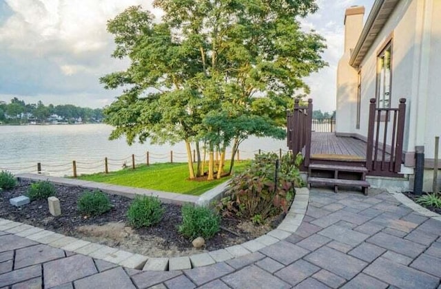 view of patio with a deck with water view