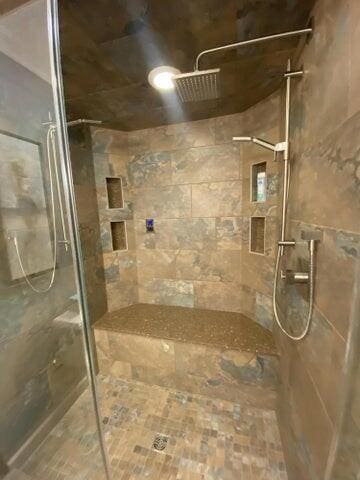 bathroom with a tile shower