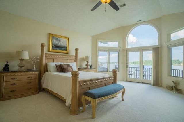 carpeted bedroom featuring ceiling fan, access to exterior, and lofted ceiling