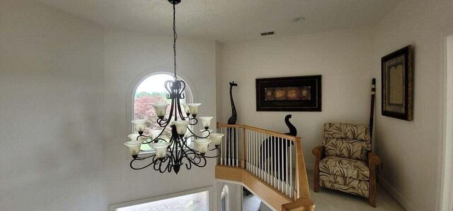 interior details featuring an inviting chandelier