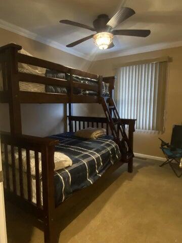 bedroom featuring ceiling fan and ornamental molding