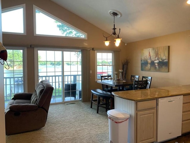 kitchen with a notable chandelier, lofted ceiling, light colored carpet, dishwasher, and hanging light fixtures