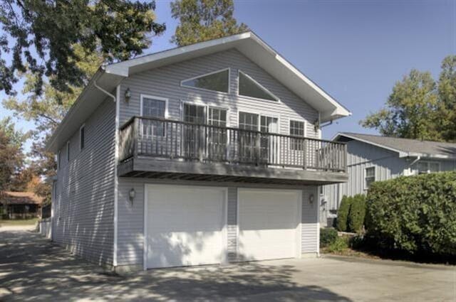 view of front of home with a balcony and a garage