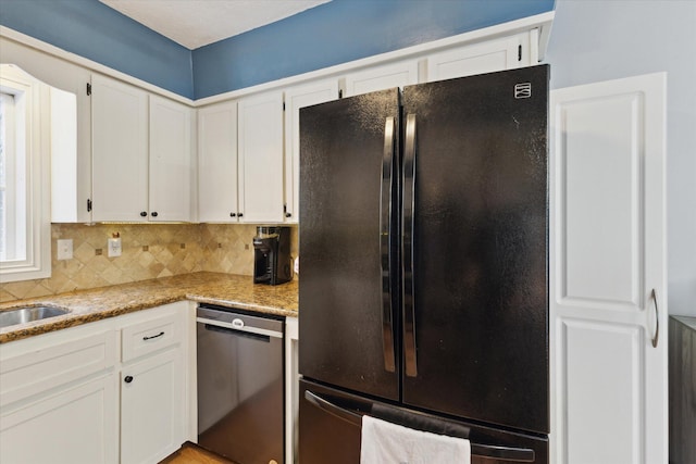 kitchen with light stone countertops, white cabinetry, and black appliances