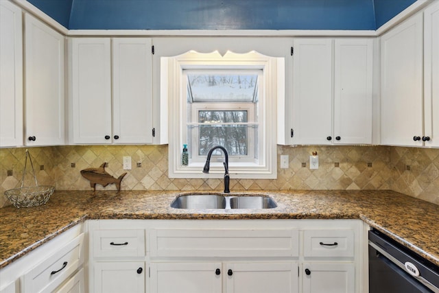 kitchen featuring white cabinetry, black dishwasher, dark stone counters, and sink