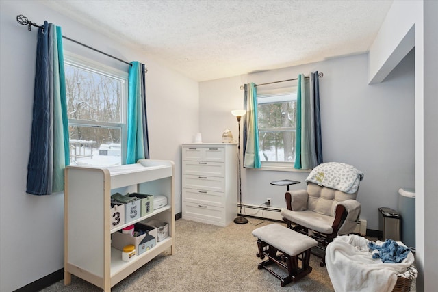 living area featuring light colored carpet, a textured ceiling, and a baseboard radiator