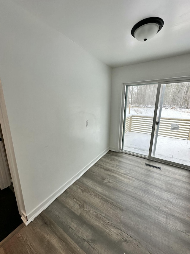 unfurnished room with wood-type flooring