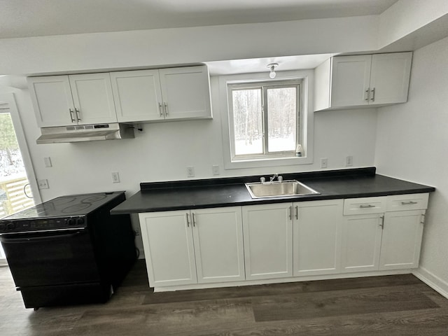 kitchen with white cabinets, electric range, sink, and dark hardwood / wood-style floors