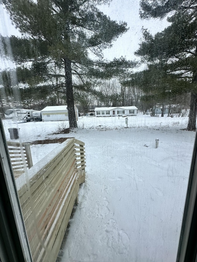 view of yard layered in snow