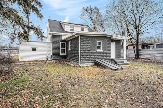 back of house with a lawn