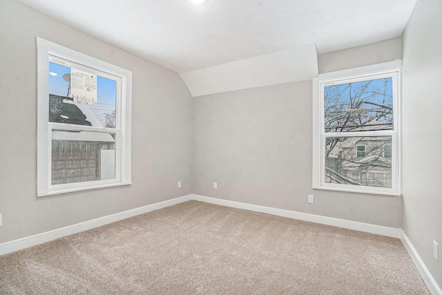 additional living space with lofted ceiling and carpet flooring