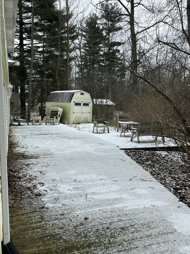 yard layered in snow with a shed