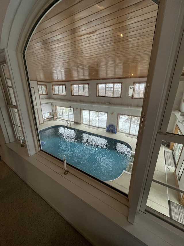 view of swimming pool featuring a hot tub