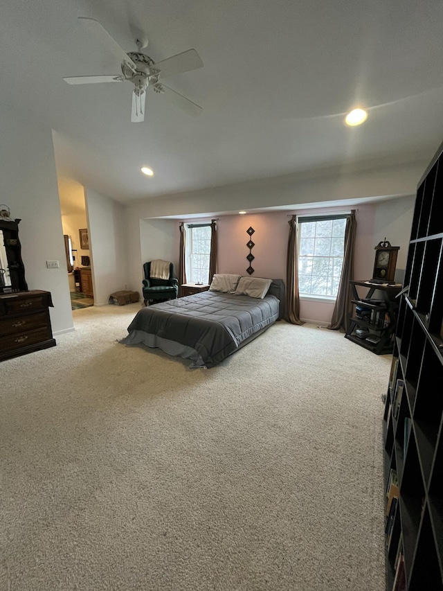 bedroom with ceiling fan, carpet, and multiple windows