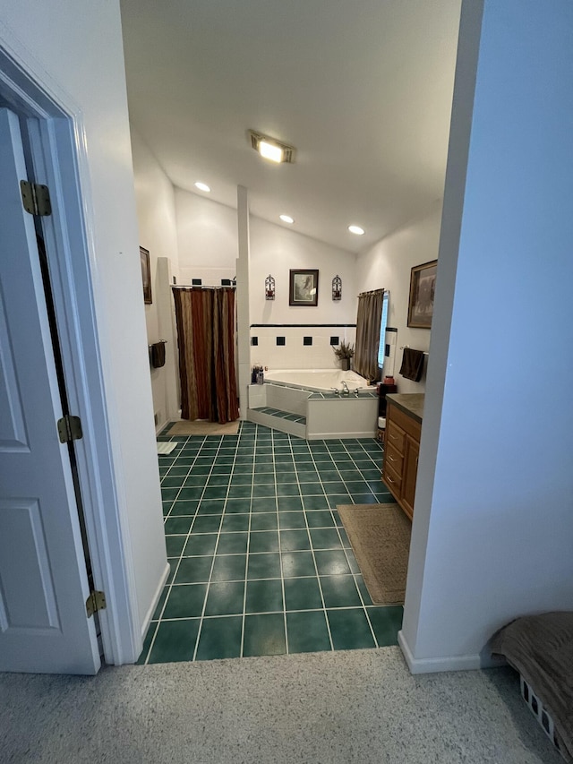 bathroom with a bath, tile patterned flooring, lofted ceiling, and vanity