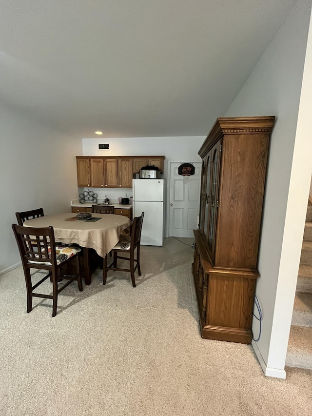 dining space with light colored carpet