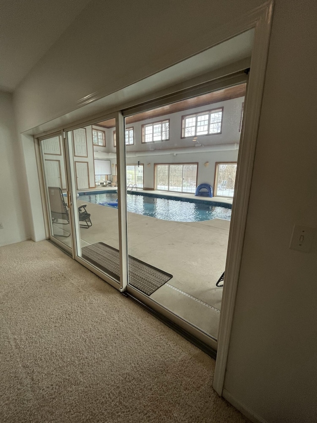 doorway to outside with carpet floors