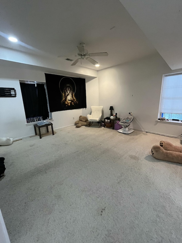 interior space with carpet floors and ceiling fan