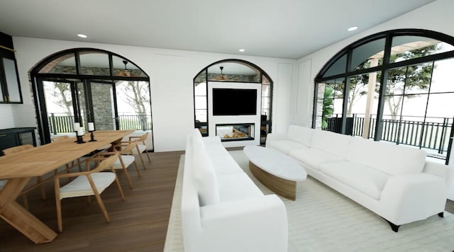 living room with a multi sided fireplace and hardwood / wood-style flooring